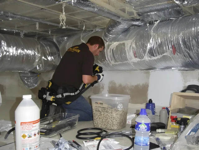 Swampscott Air Duct Cleaning specialist performing professional mold removal from air ducts in Swampscott