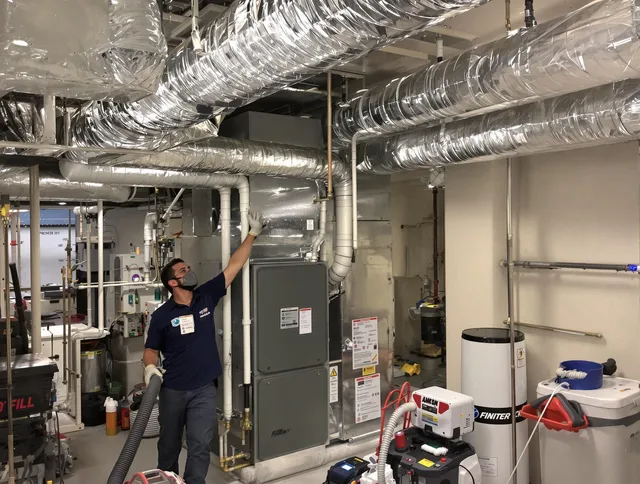 Swampscott Air Duct Cleaning specialist performing thorough furnace duct cleaning in a Swampscott residence