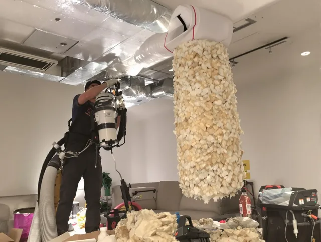 Swampscott Air Duct Cleaning technician performing precision vacuum insulation removal in a residential property in Swampscott
